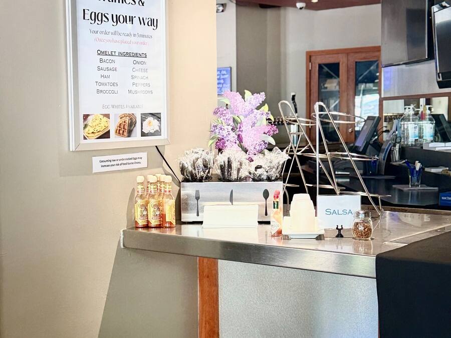 A breakfast counter with a menu for omelets, waffles, and eggs.