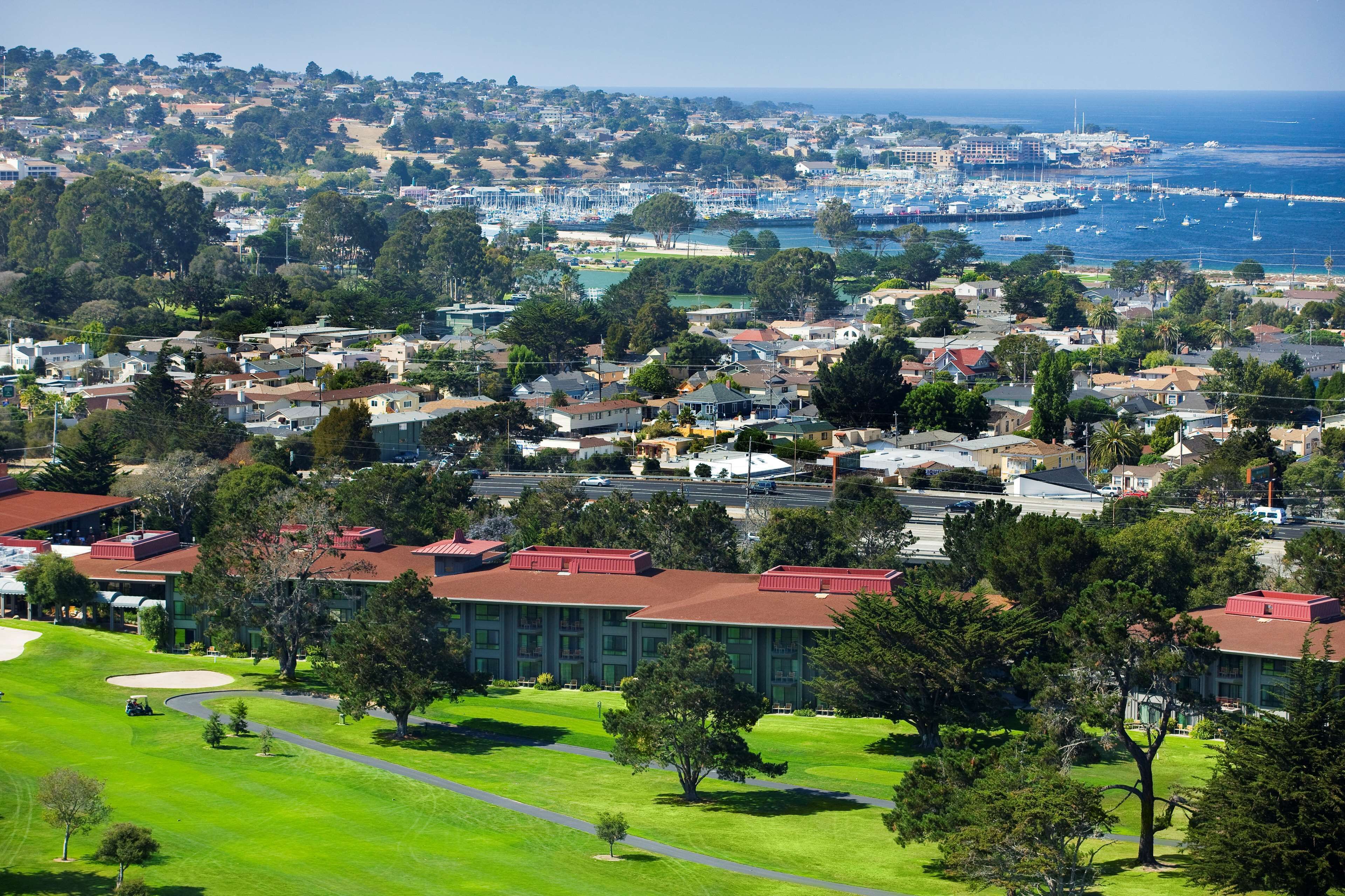 A coastal town with a marina, residential buildings, and a golf course.
