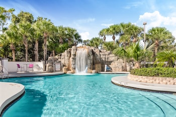 Outdoor pool, sun loungers at Crowne Plaza Orlando - Lake Buena Vista , an IHG Hotel