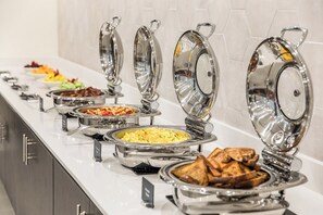 A buffet with various food options, including scrambled eggs, toast, and other dishes. - Crowne Plaza Orlando - Lake Buena Vista  by IHG (Orlando)