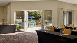 A conference room with a large table, chairs, and a glass partition. - Crowne Plaza Orlando - Lake Buena Vista  by IHG (Orlando)