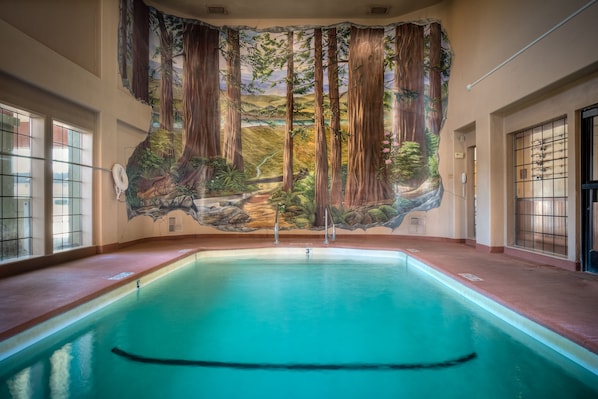 A swimming pool with a mural of a forest scene on the wall above. - The Redwood Riverwalk, A Boutique Hotel (Fortuna)