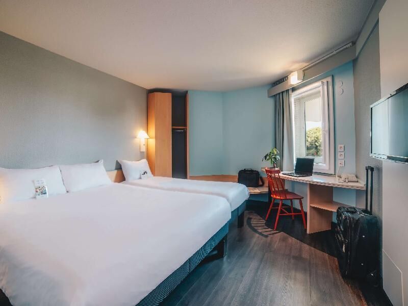 Hypo-allergenic bedding, desk, laptop workspace, blackout drapes