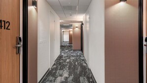 A hotel hallway with a number 412 door, a patterned carpet, and a ceiling with recessed lighting. - ibis Nice Aéroport Promenade des Anglais (Nice)