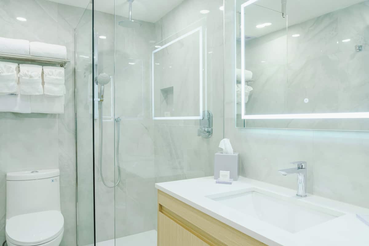 Premium Room, 2 Queen Beds, Partial Ocean View | Bathroom | Shower, rainfall showerhead, free toiletries, hair dryer