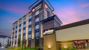 Un hotel con un llamativo letrero de "Premier Best Western", varios pisos y un letrero que dice "Jonathan's Lounge".