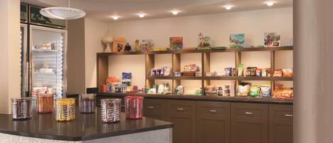 A self-service food station with various snacks and beverages, a refrigerated display, and a clean, modern design.
