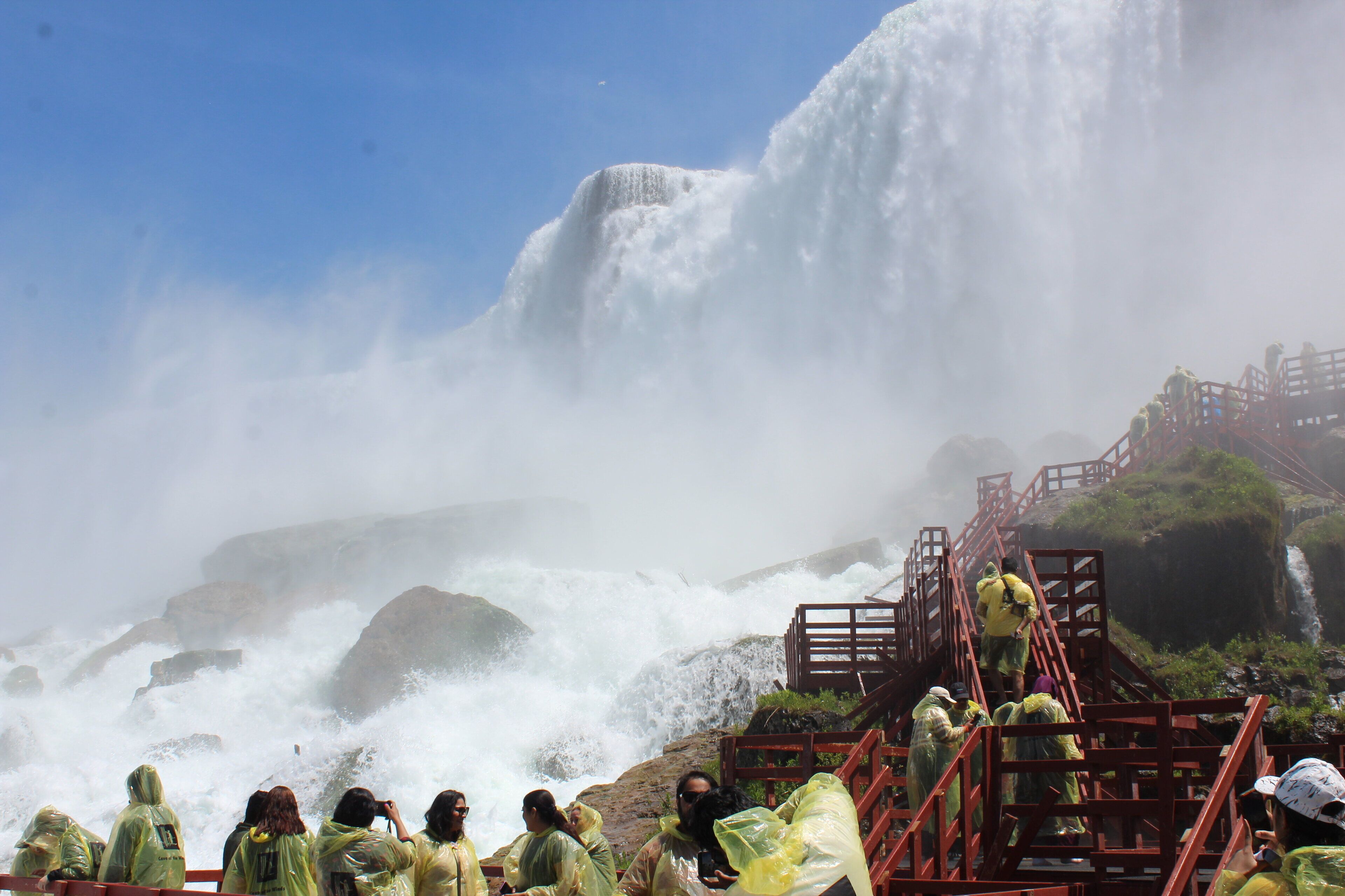 A waterfall with a viewing platform and steps leading up to it.