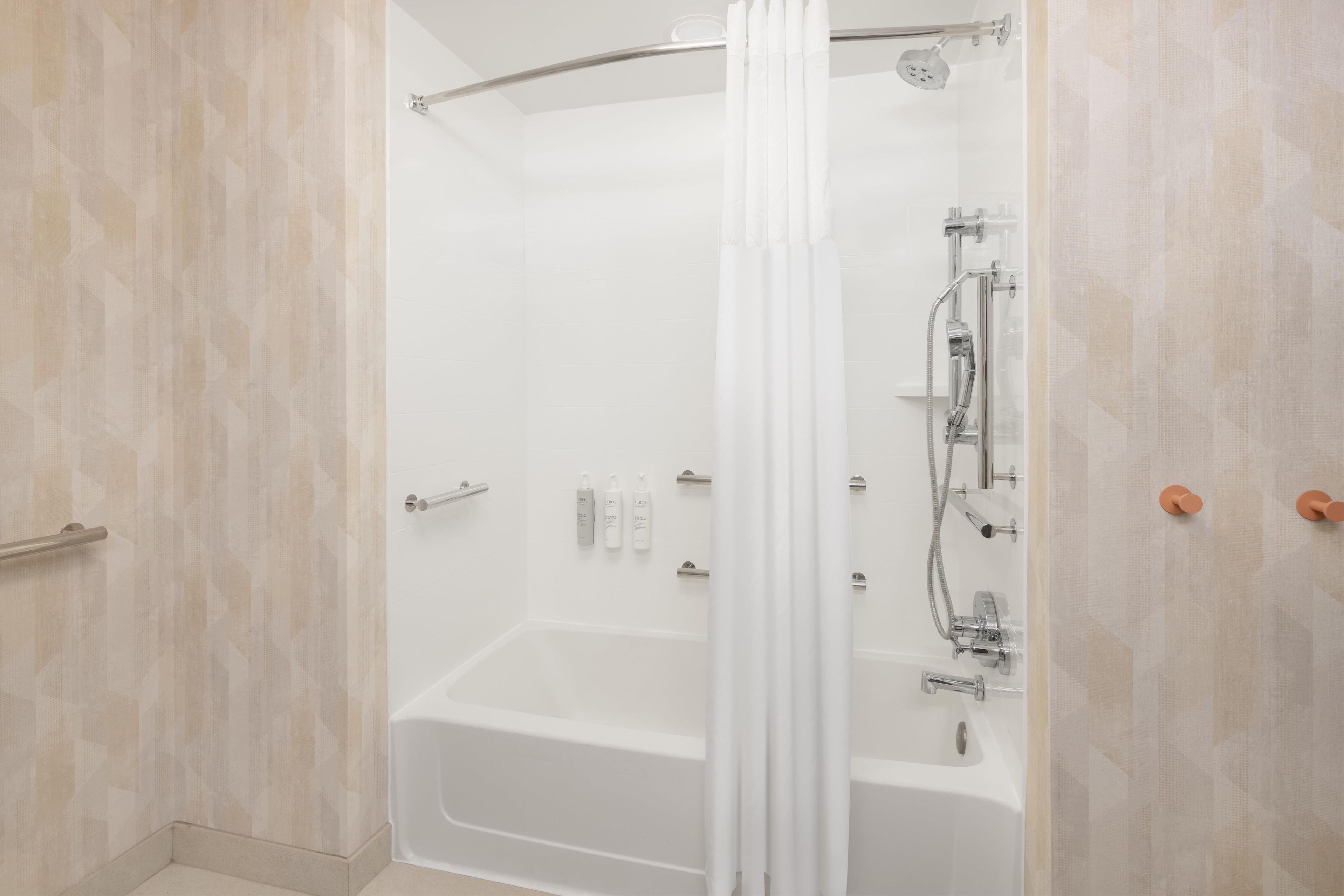 A modern bathroom with a walk-in shower, a bathtub, and a toilet.