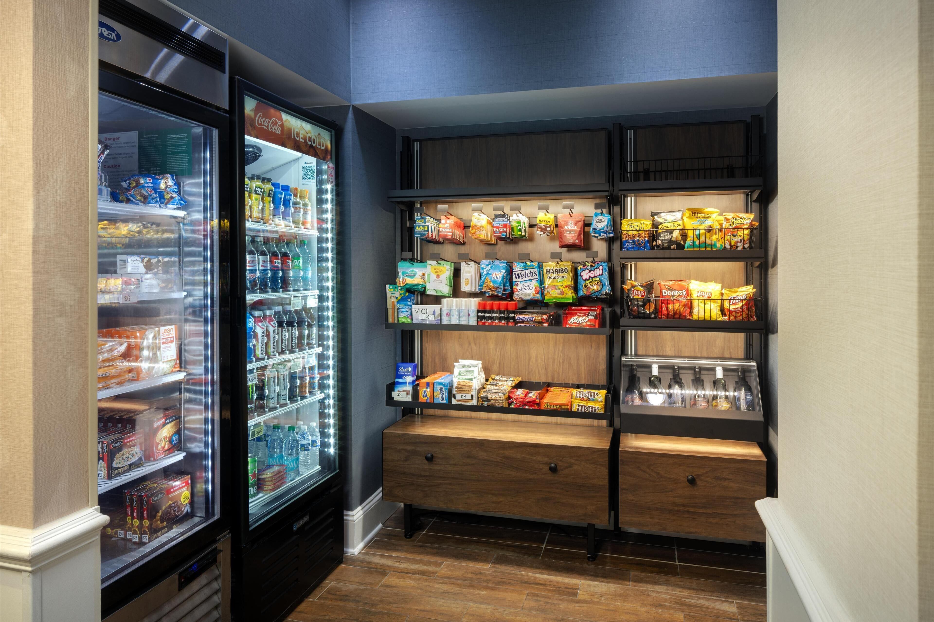 A snack and beverage vending area with refrigerated and non-refrigerated options, including chips, snacks, and bottled water.