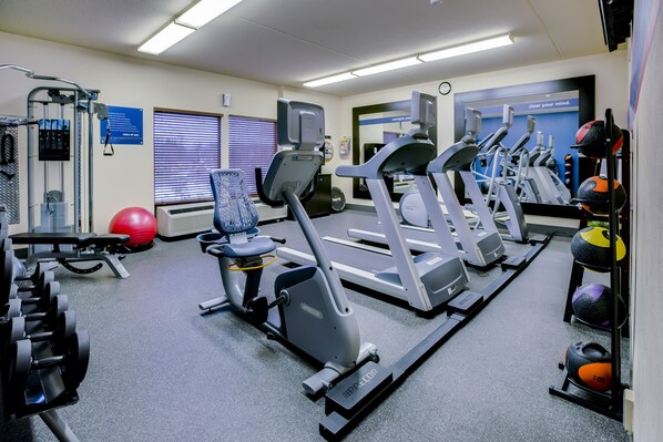 A gym with treadmills, elliptical machines, and free weights. - Pittsburgh Airport Inn and Suites (Coraopolis)