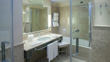 A modern bathroom with a glass-enclosed shower, a double sink vanity, and a large mirror.