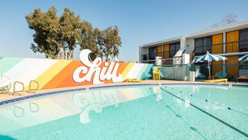 Outdoor pool, a heated pool, open 9:00 AM to 9:00 PM, pool loungers