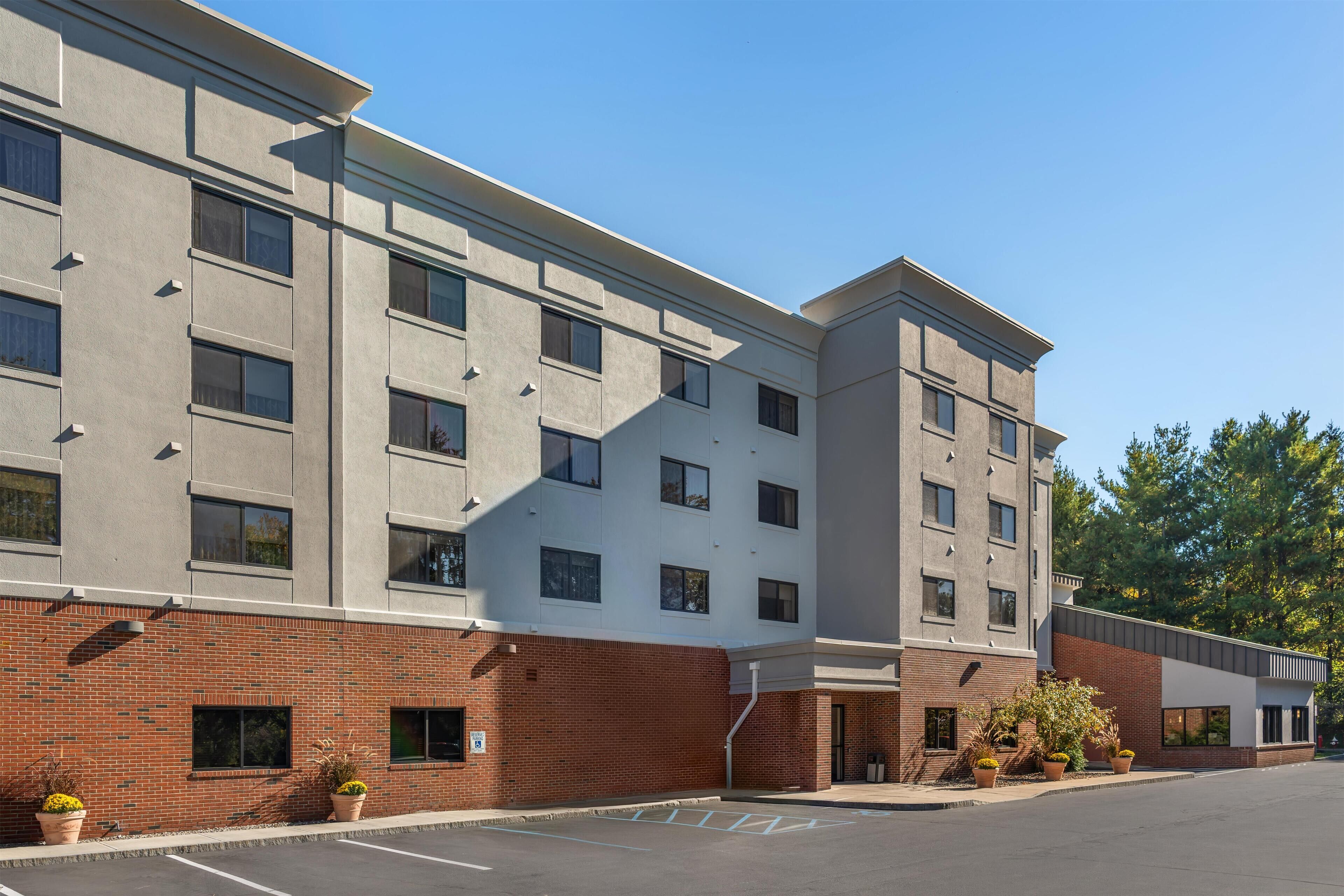 A multi-story hotel with a brick facade and large windows.