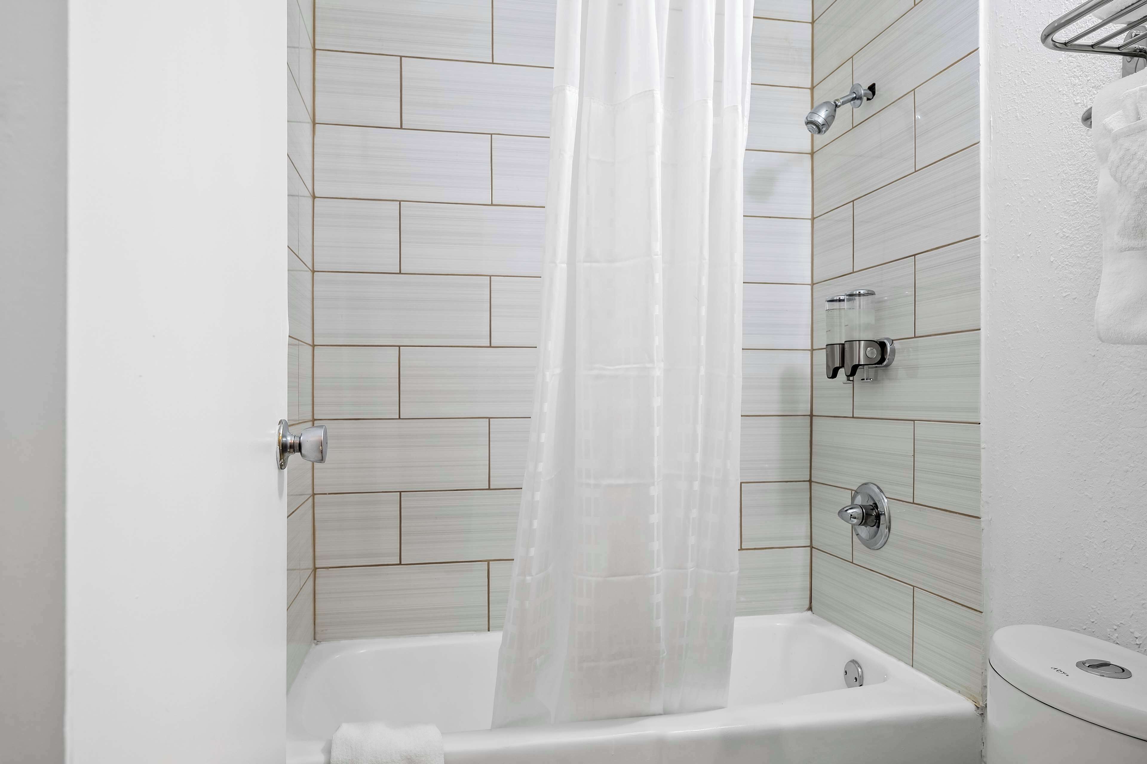 A bathroom with a bathtub, a shower, and a toilet.