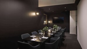 A conference room with a long table, chairs, and a plant centerpiece. - The Victoria Hotel Melbourne (Melbourne)