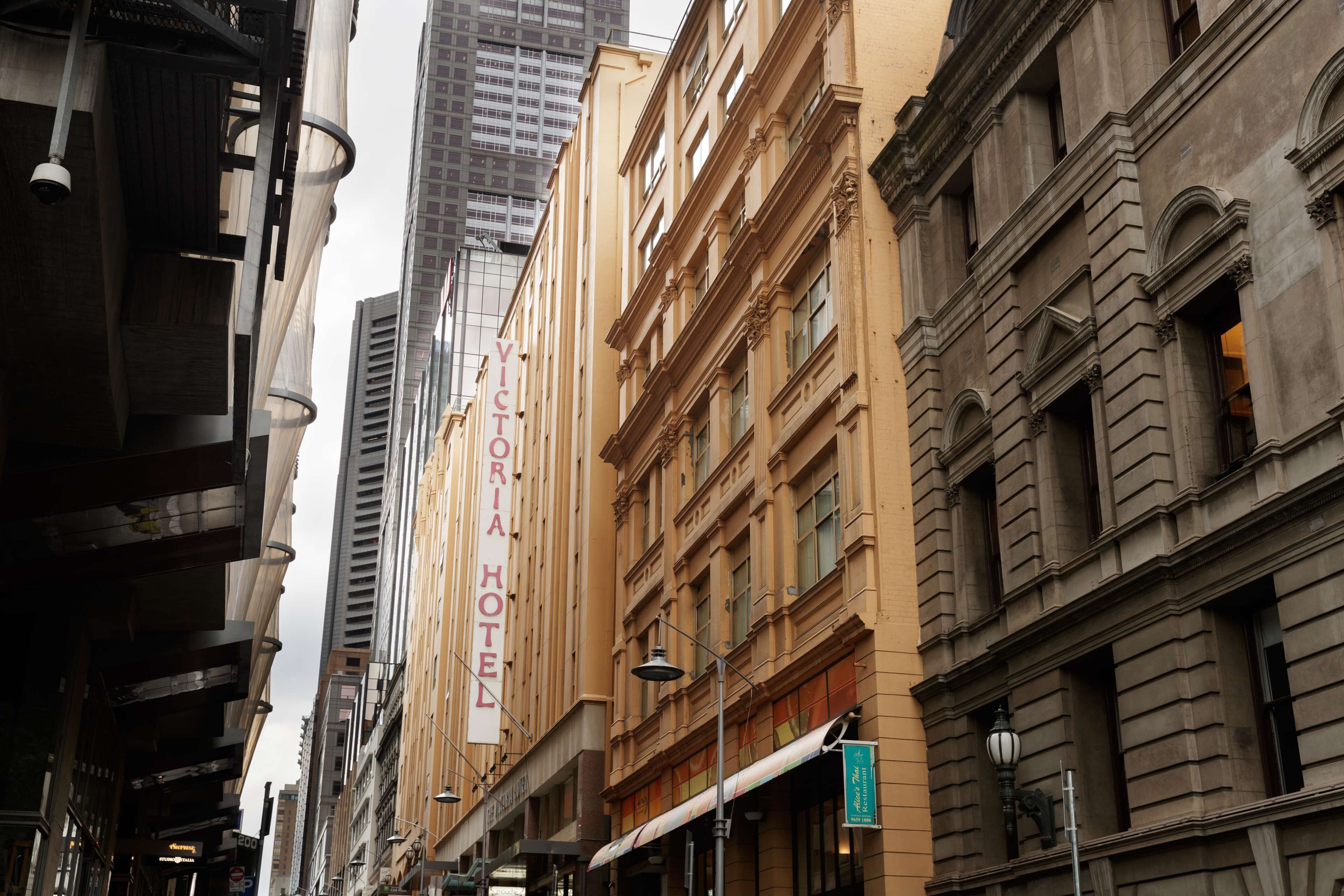 A historic hotel building with a prominent sign reading "Victoria Hotel".