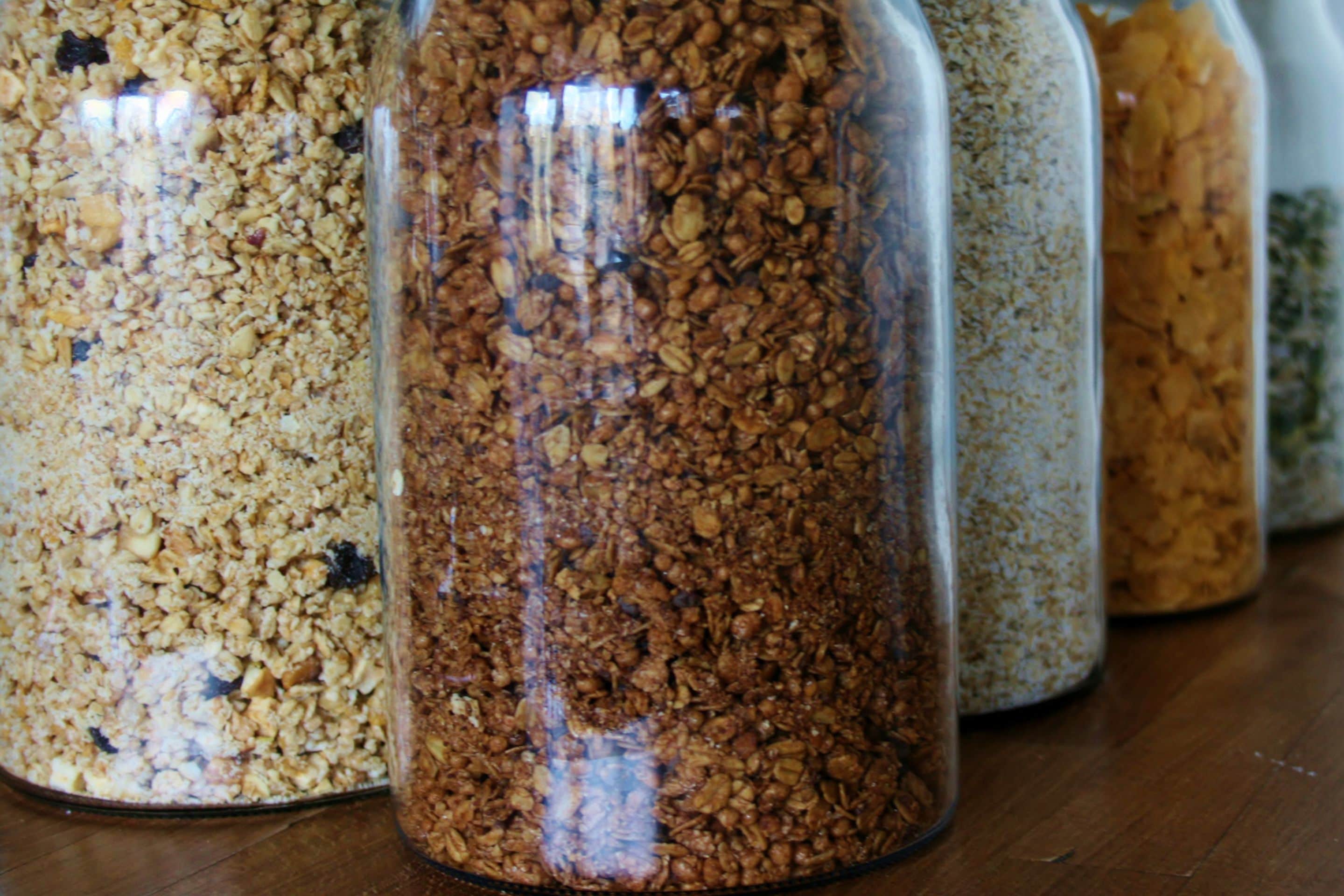 A row of glass jars filled with granola.