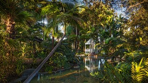 A serene garden with a pond, lush greenery, and a gazebo. - Bahia Resort Hotel (San Diego)