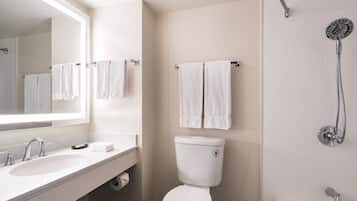 A modern bathroom with a white sink, toilet, and shower.