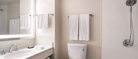 A modern bathroom with a white sink, toilet, and shower.