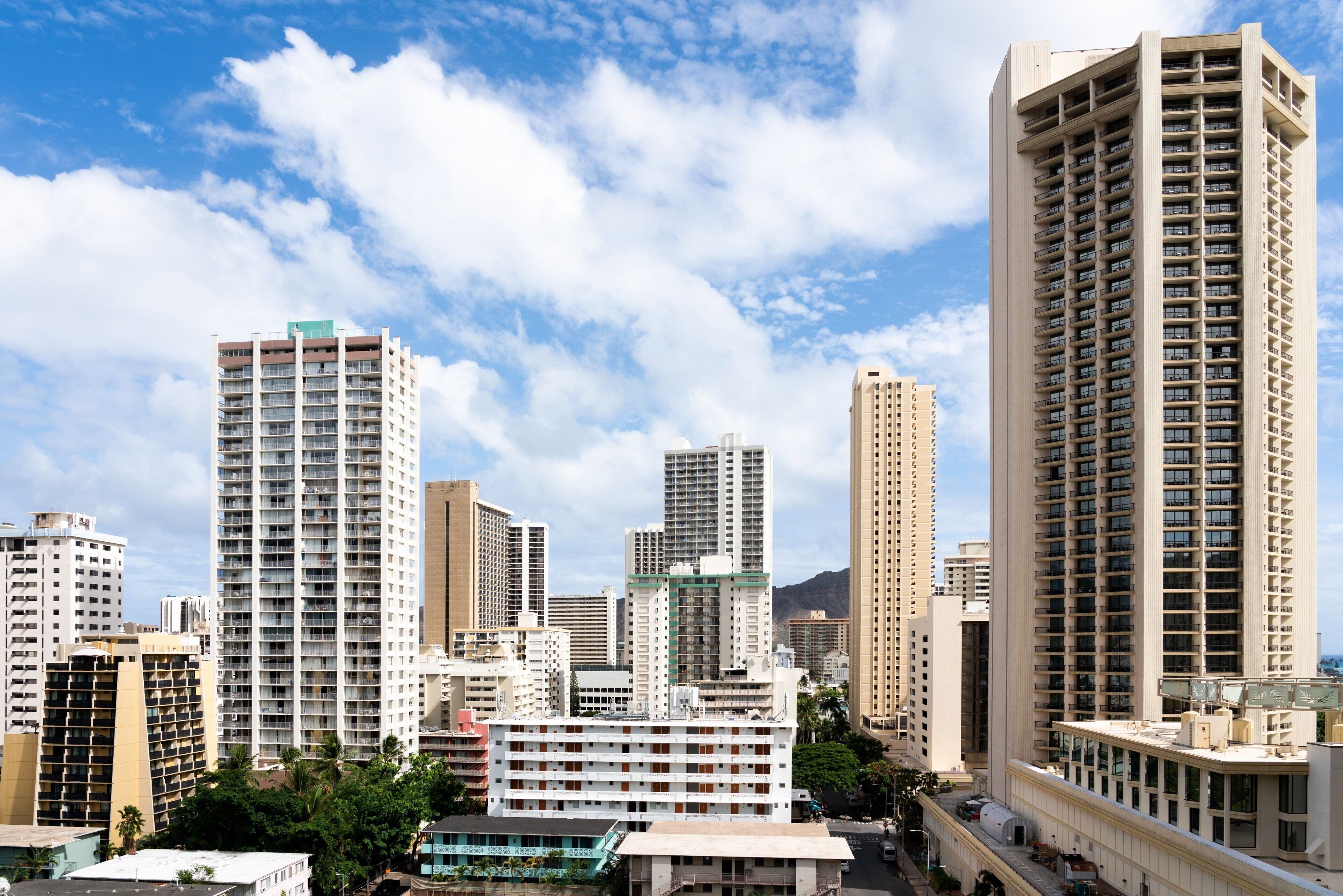 A cityscape with high-rise buildings, including a prominent hotel with multiple floors and balconies.