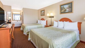 A hotel room with two beds, a desk, a TV, and a bathroom visible through a door. - Days Inn by Wyndham Princeton (Princeton)