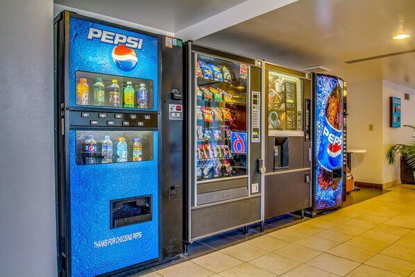 A row of vending machines with Pepsi branding, including a water dispenser and snack options.