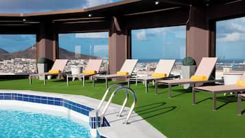 Outdoor pool, open 11:00 AM to 7:00 PM, pool umbrellas, pool loungers