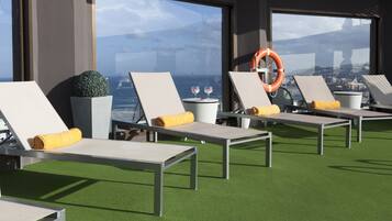 Outdoor pool, open noon to 6:00 PM, pool umbrellas, pool loungers