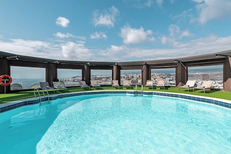 Outdoor pool, open noon to 6:00 PM, pool umbrellas, sun loungers