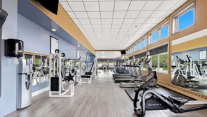 A modern gym with cardio machines, weight stations, and large windows offering natural light. - Best Western Plus Nor'wester Hotel & Conference Centre (Thunder Bay)