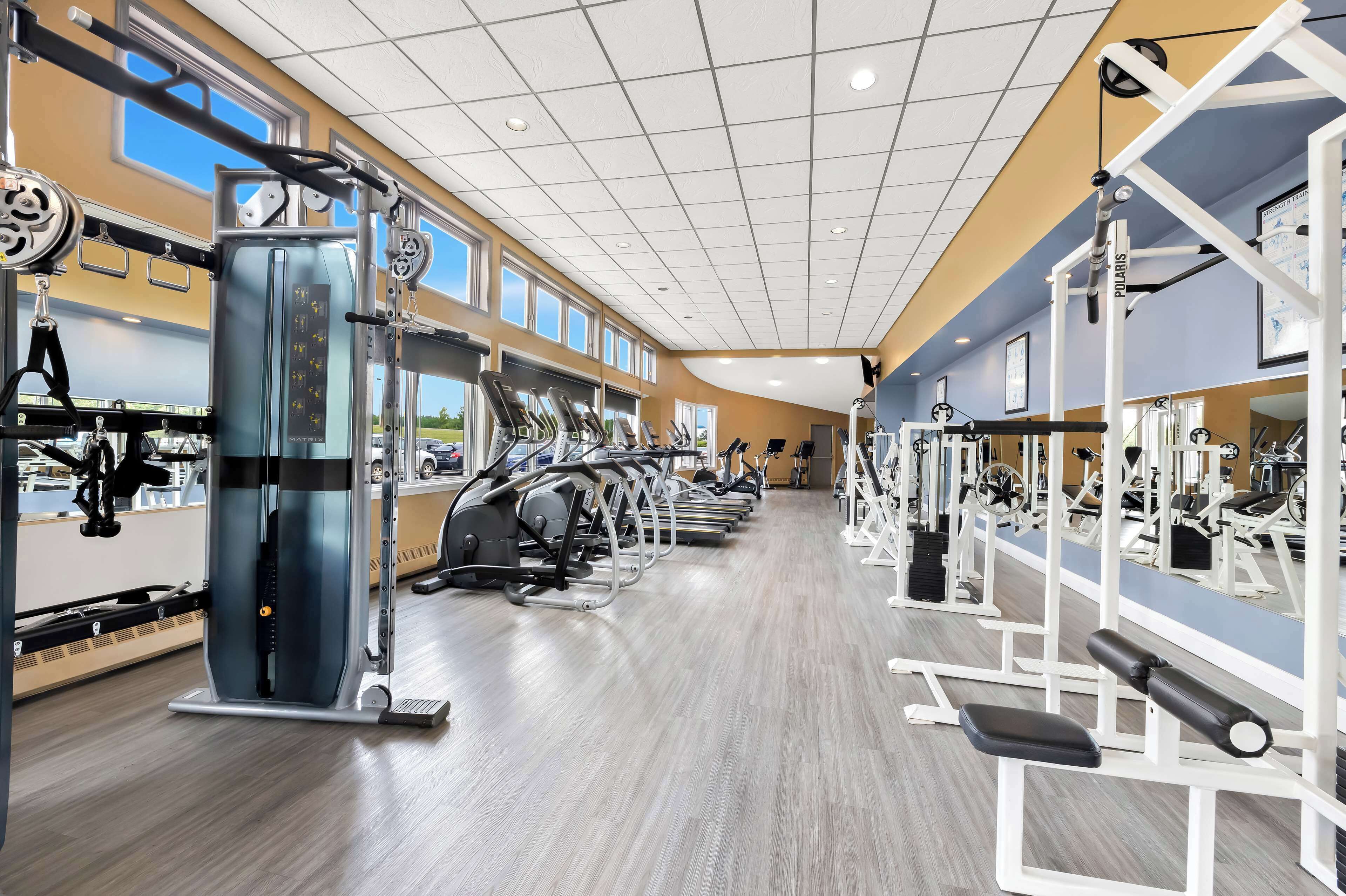 A gym with treadmills, weight machines, and exercise equipment.
