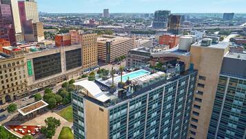 A high-rise building with a rooftop pool, a large glass facade, and a visible 'UN System' sign.
