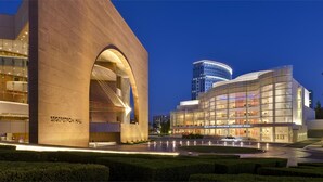 A modern concert hall with a large arched entrance and a glass facade. - Crowne Plaza Costa Mesa Orange County by IHG (Costa Mesa)