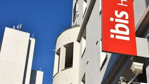 A hotel building with a prominent red sign reading "Ibis Hotel". - ibis Nancy Centre Gare et Congres (Nancy)
