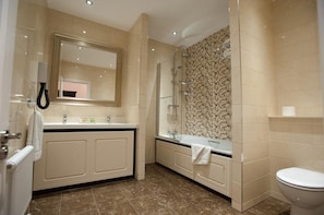A modern bathroom with a large mirror, a glass shower enclosure, and a toilet. - The Dukes Head Hotel (King's Lynn)