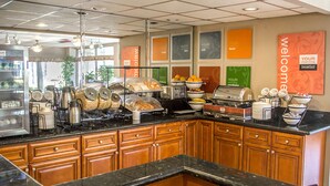 A breakfast buffet with various food items and a welcoming sign. - Quality Inn Riverside near UCR and Downtown (Riverside)