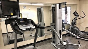 A gym with treadmills, a stationary bike, and a weight machine. - Quality Inn Riverside near UCR and Downtown (Riverside)