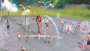 A water play area with multiple water jets and structures for children to interact with.