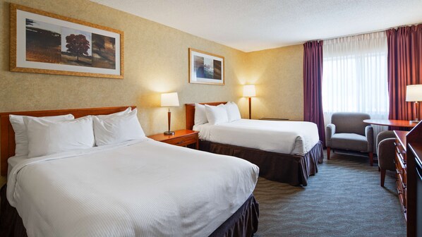A hotel room with two beds, a desk, a chair, and two lamps. - Best Western North Bay Hotel & Conference Centre (North Bay)