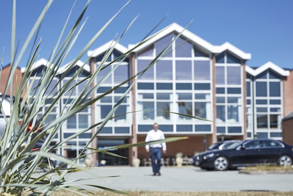 A building with large windows and a person walking in front.