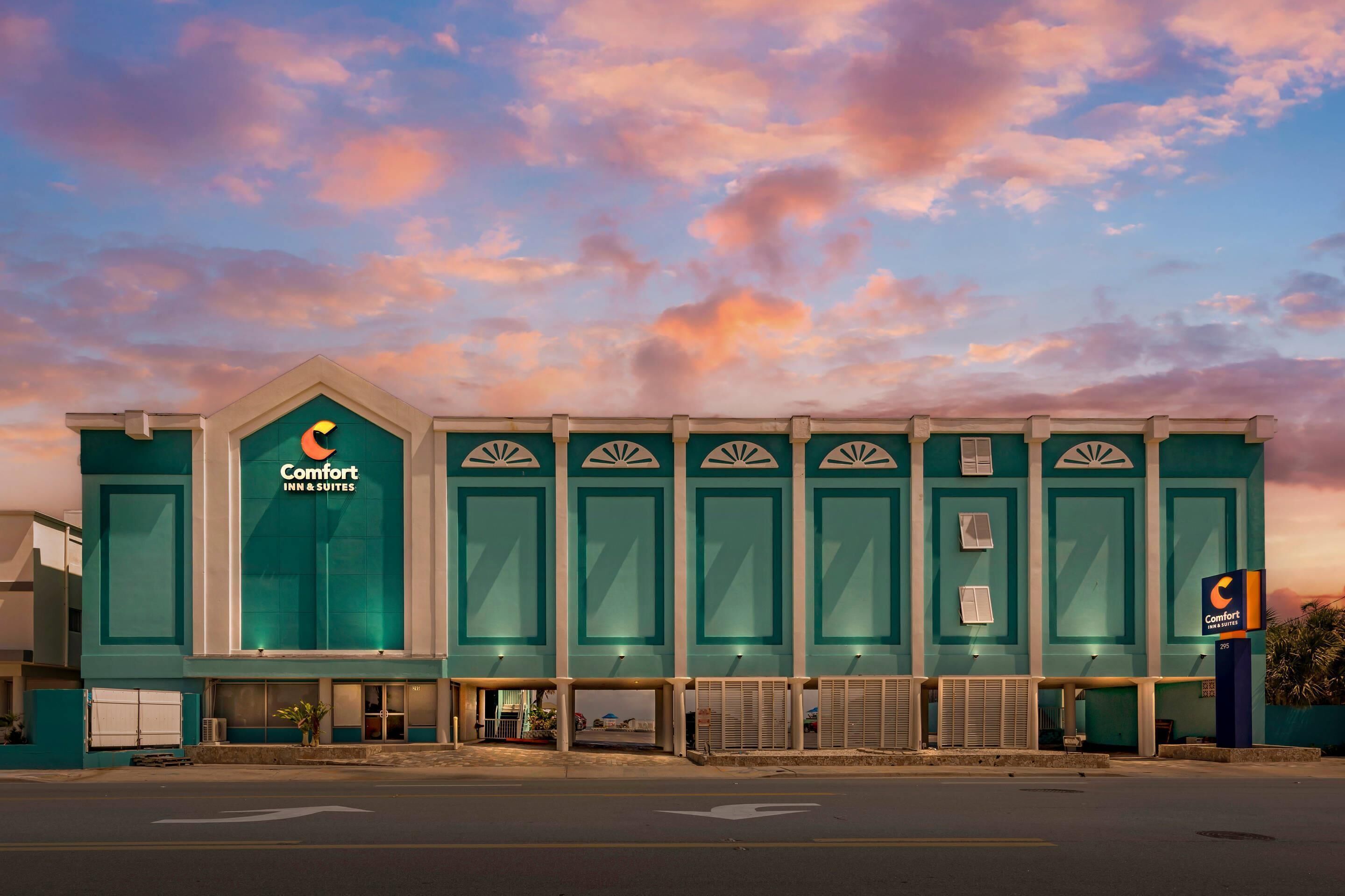 A Comfort Inn & Suites hotel with a prominent sign, a flat roof, and a large entrance.