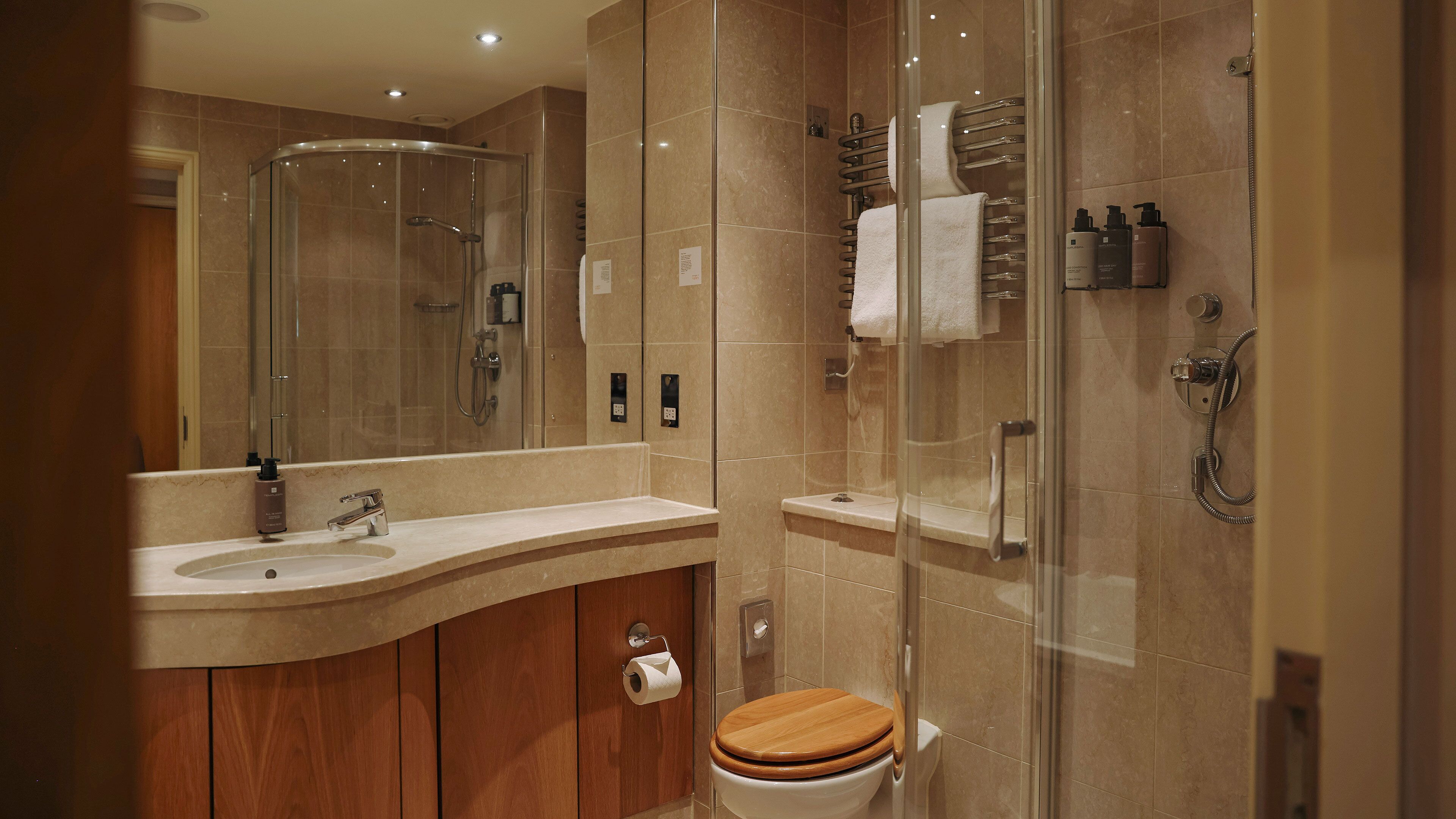 combined shower/bathtub, designer toiletries, hair dryer, slippers