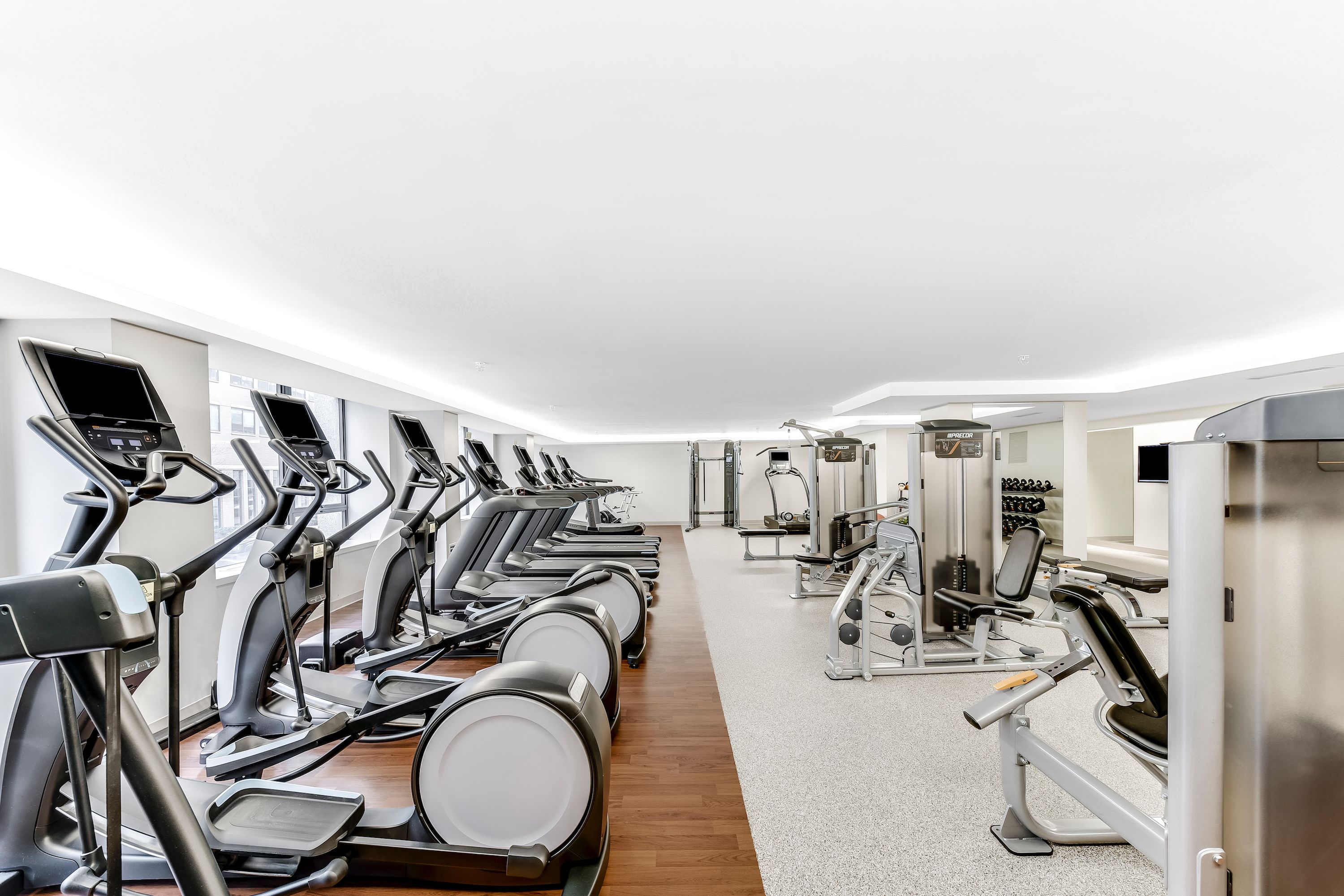 A gym with multiple treadmills, weight machines, and cardio equipment.