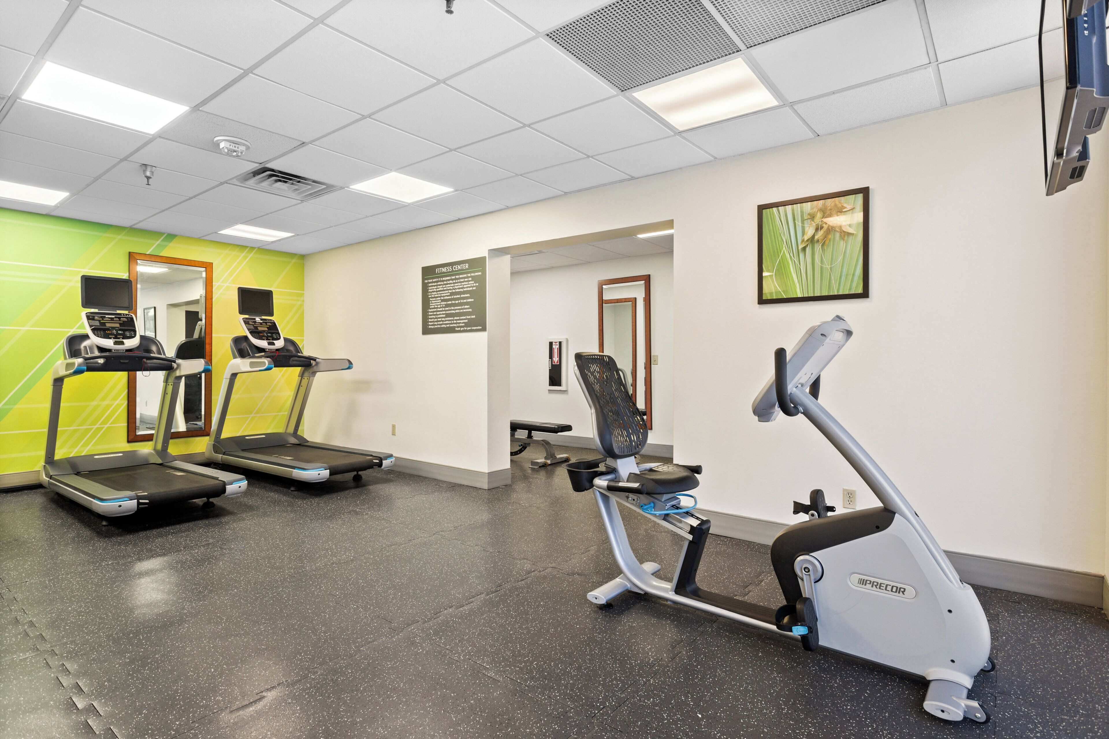 A fitness center with treadmills and an elliptical machine.