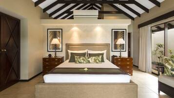 A bedroom with a large bed, wooden headboard, two bedside tables, and a nightstand.