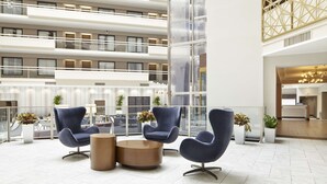 A spacious lobby with modern seating and a high ceiling. - Embassy Suites by Hilton Atlanta Galleria (Atlanta)