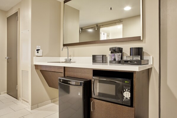 A compact kitchenette with a refrigerator, microwave, coffee maker, and a small sink. - Embassy Suites by Hilton Atlanta Galleria (Atlanta)