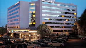 A multi-story building with the sign "Embassy Suites" indicating it is a hotel.